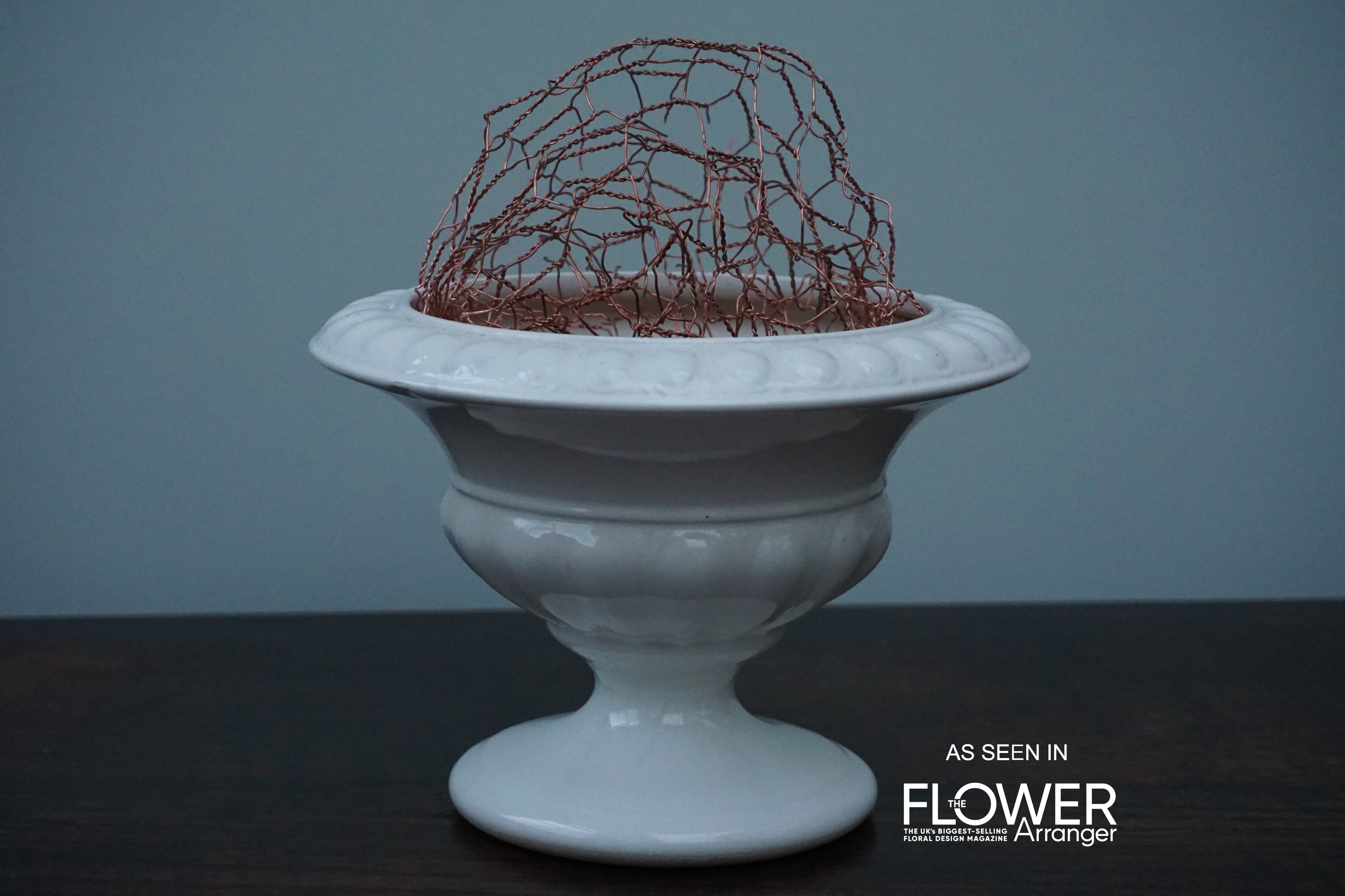 Pure copper Flowercomb® sustainable flower arranging product showcased in a vase highlighting sustainable and reusable design